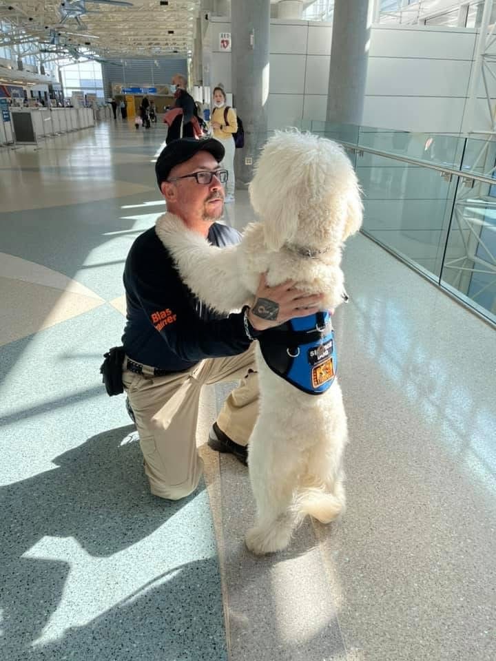 Blas L. Cardenas with a service dog at the airport